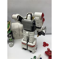 Collection of early 90s Mighty Morphin’ Power Rangers Zords, figures and accessories. Titanus the Carrier Zord, marked Bandai 1991; Green Dragonzord, incomplete; 1994 White Tigerzord with original instruction manual; 1993 Triceratops Dinozord, Mastodon Dinozord and Sabertooth Tiger Dinozord, Pterodactyl Dinozord, missing guns; with 1993 Power Morpher and original Power Coins, with further related figures, accessories and weapons