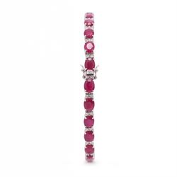 18ct white gold ruby and diamond bracelet, twenty-six oval cut rubies, each spaced by two round brilliant cut diamonds, stamped 750, total ruby weight 12.70 carat, total diamond weight 0.46 carat