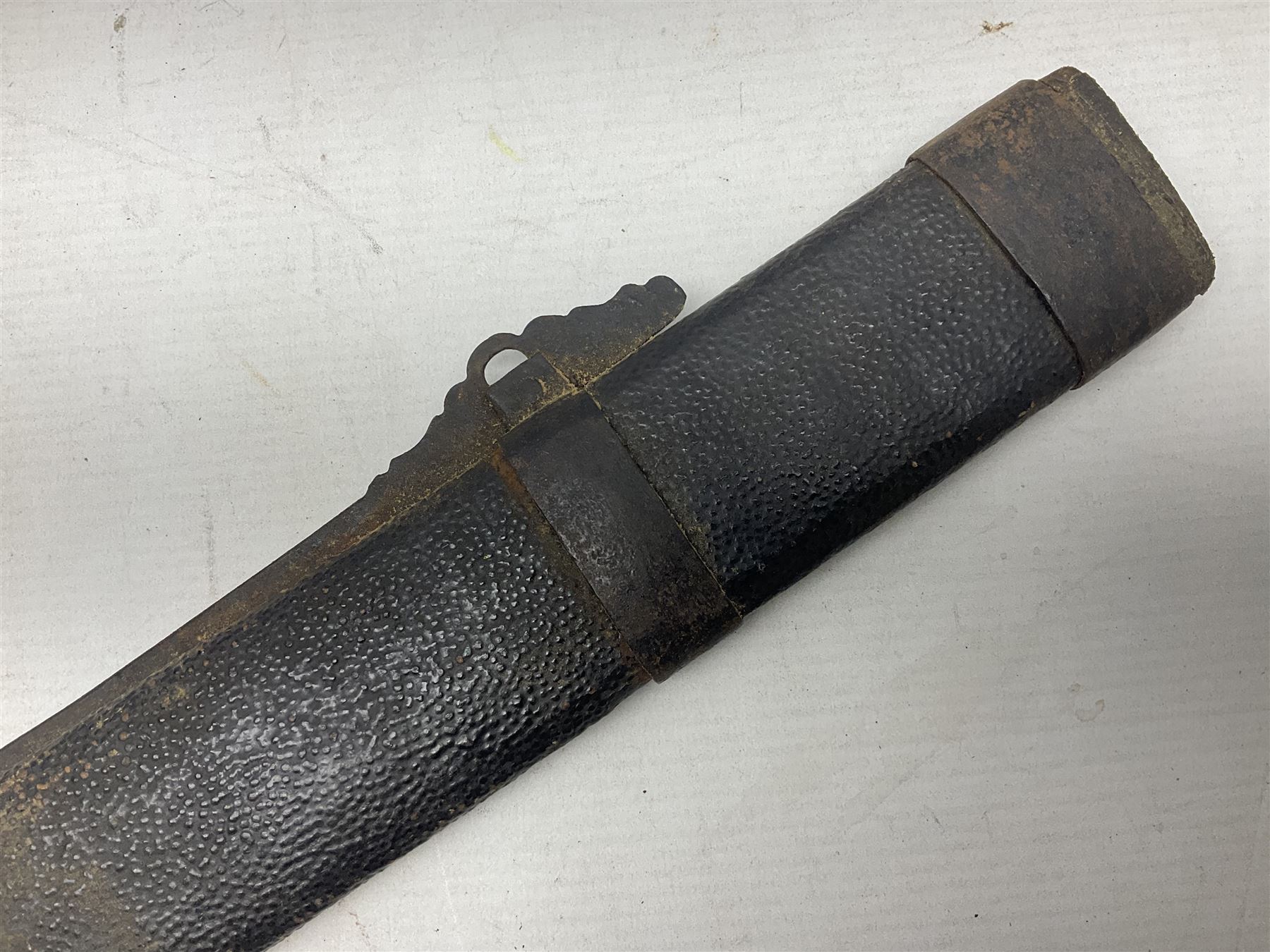 Chinese Boxer Rebellion Period Sword, 69.5cm heavy curved single edge blade with single narrow fuller, plain iron dished circular guard, iron pommel and ferrule with plaited cord bound grip; in skin covered wooden scabbard with iron chape and long suspension mount L95cm overall