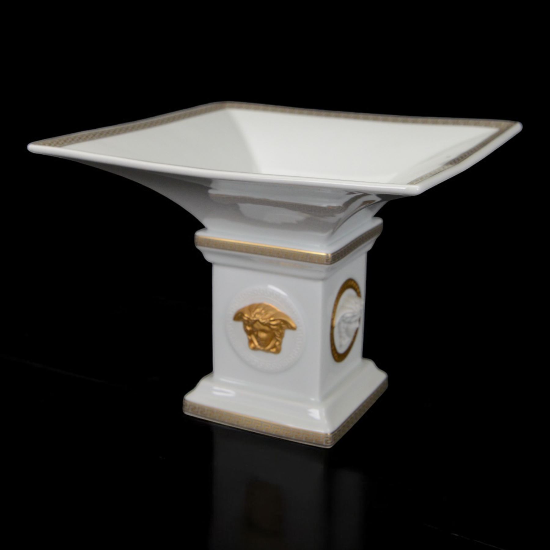 Rosenthal Versace Gorgona pedestal dish, of square form, decorated in relief with Medusa masks and with gilt Greek key borders to the rim and base, boxed, H15cm