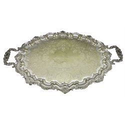 large twin-handled tray with scrolling border decorated shells, engraved with floral and foliate decoration to the centre 