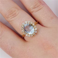 18ct gold aquamarine and diamond cluster ring, single oval cut aquamarine of approx 2.05 carat, surrounded by sixteen round brilliant cut diamonds, stamped, total diamond weight 0.40 carat