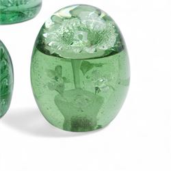 Eleven Victorian and later green glass dump paperweights, with floral and bubble inclusions, largest H14cm 