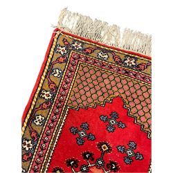 Small Persian Arak rug, red ground and decorated all-over with Boteh motifs (90cm x 56cm); a similar larger Persian Arak (126cm x 60cm); and a Persian red ground rug with extending stylised flower head design (123cm x 60cm)