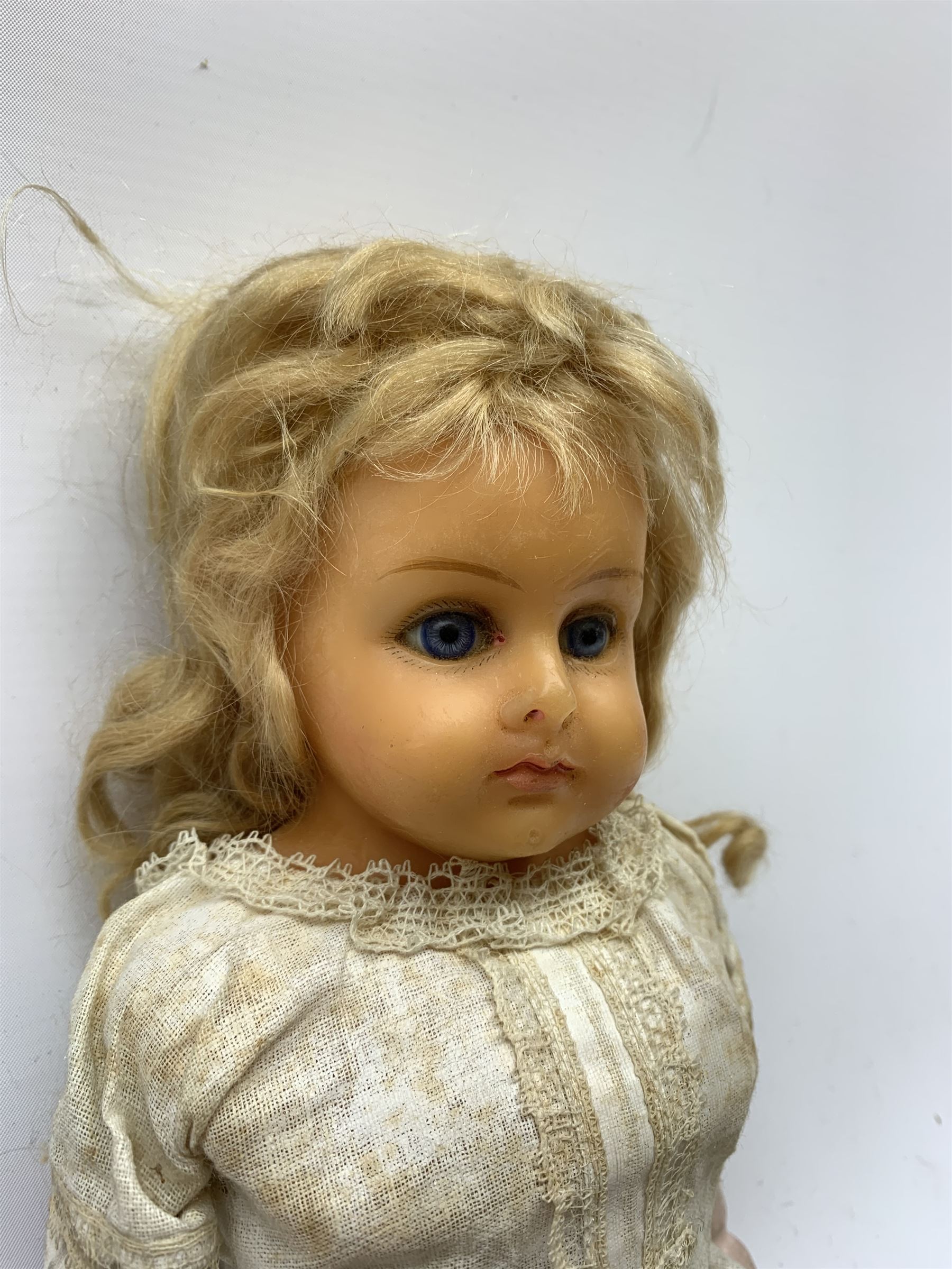 Early 20th century Cuno and Otto Dressel wax shoulder head doll with applied hair and fixed glass eyes, soft body with jointed composition lower limbs, maker's stamp to right thigh, clothing and box H38cm in original box