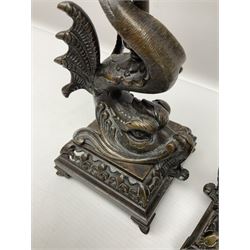 Pair of late 19th/ early 20th century brass candlesticks in the form of dolphins upon a stepped base with Fleur-de-lis design, H32cm 