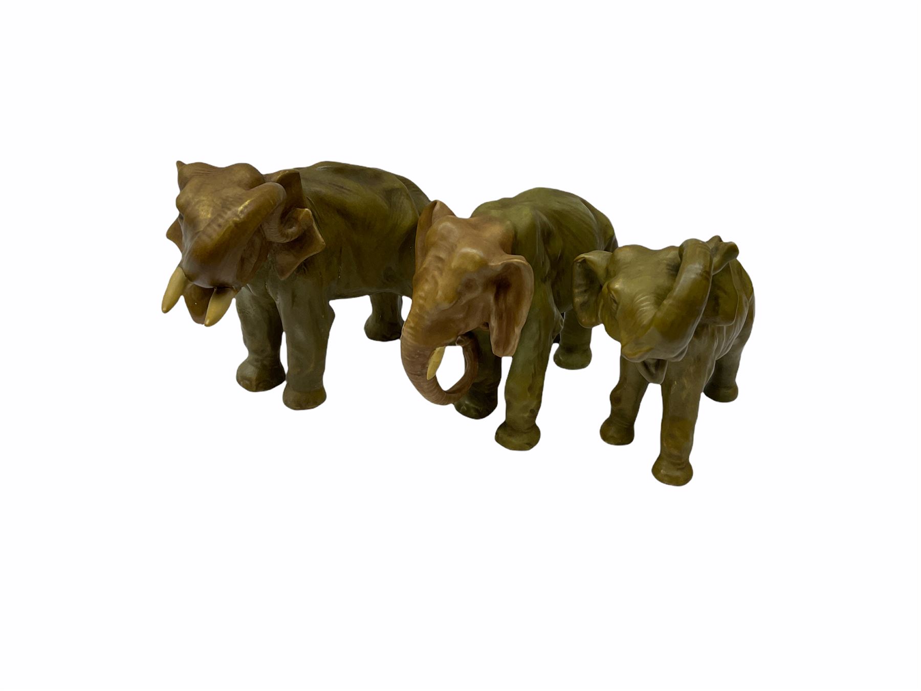 Royal Dux figure modelled as a fish seller, with applied triangle mark to the base and impressed model number 2292, H27cm, together with three Royal Dux style elephants, and a pair of Austrian Turn Wien figures, each carrying 'striker' baskets for matches. 