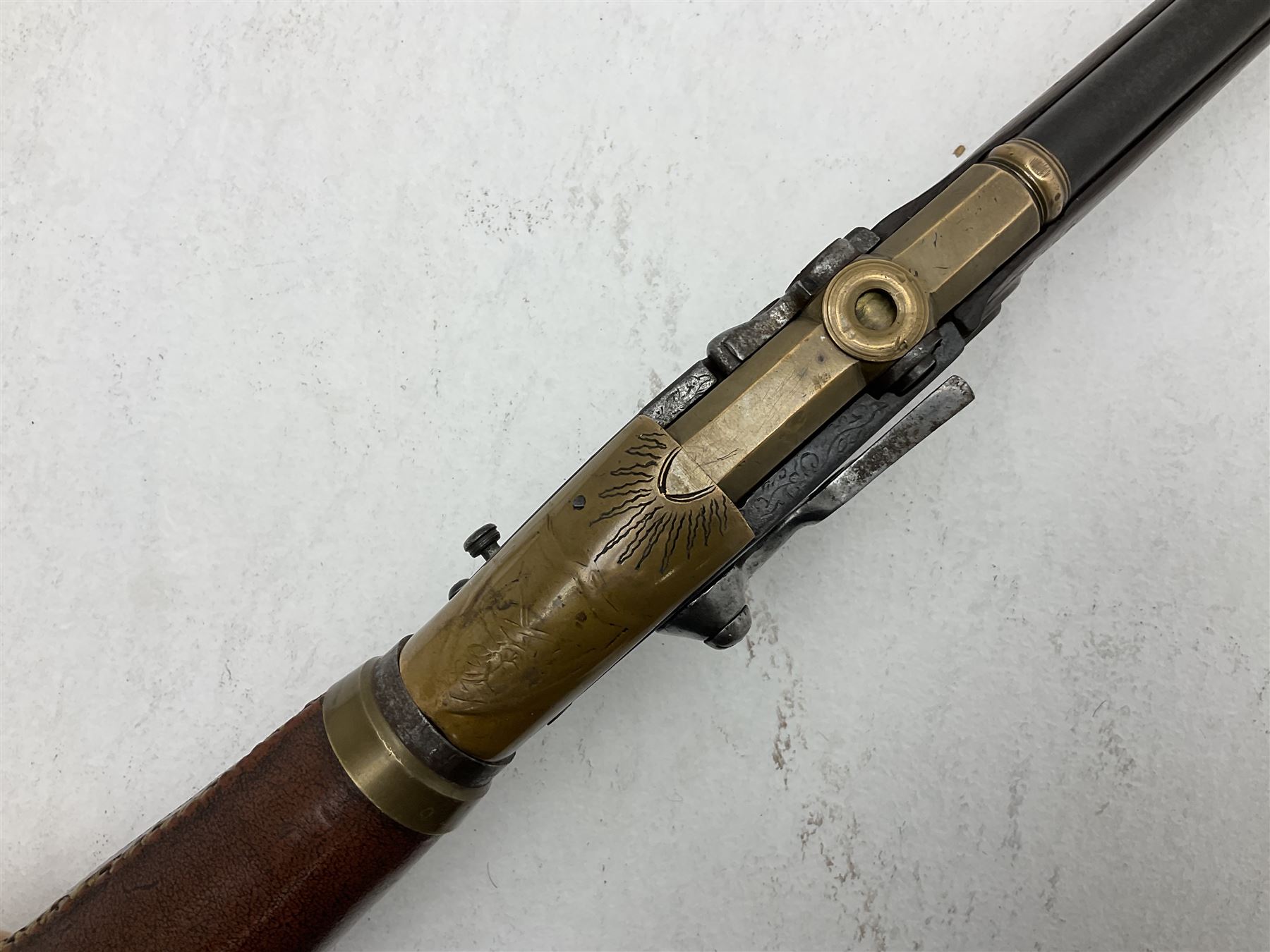 Late 18th century 7.2mm (approx. .28 calibre) Girandoni system single shot reservoir air rifle, the 62cm steel barrel with swivelling two-leaf rear sight, brass breech decorated with a sunburst and lever opening top loading, engraved steel lock-plates marked 'S. Gaskell' to the right side underneath the cocking lever, brass trigger guard,  leather covered steel butt reservoir of tapering conical form with brass ferrule and walnut fore-stock with horn mounts L107cm overall