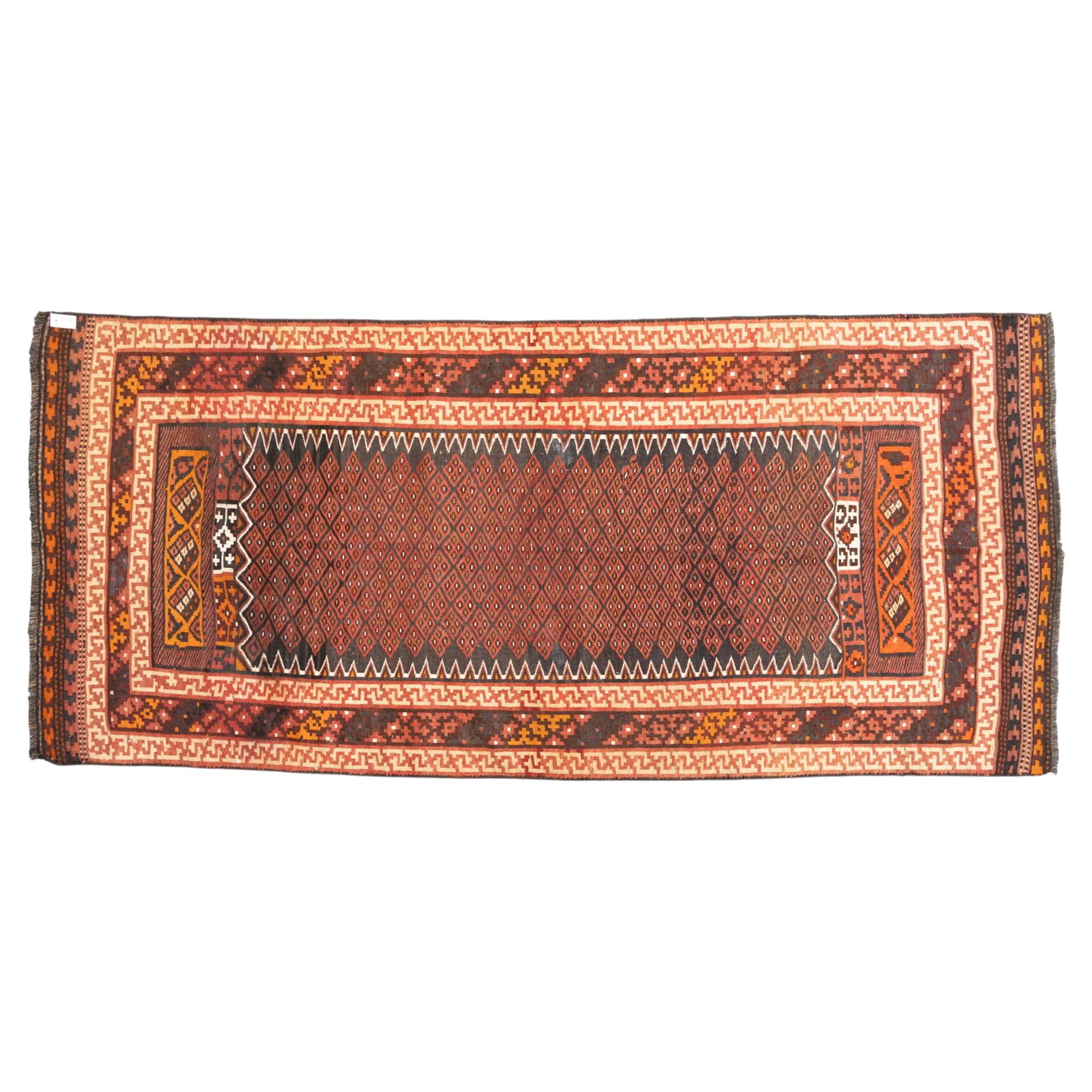 North west Persian Yamut Kilim, madder field with all-over lozenge lattice and serrated edges, with stepped end-panels and bold geometric borders in red, ivory and black