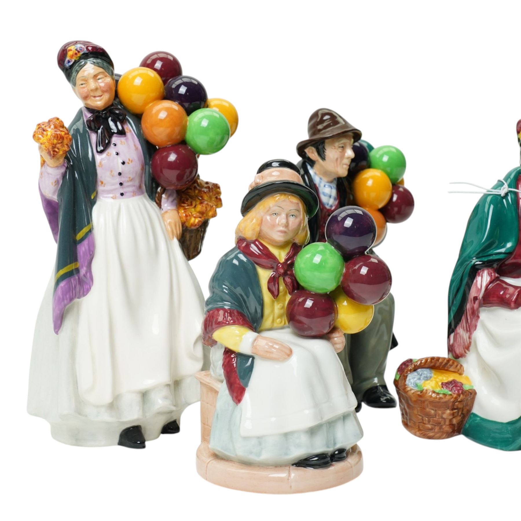 Royal Doulton figures comprising The Old Balloon Seller HN1315, The Balloon Man HN1954, Biddy Pennyfarthing HN1843 and Balloon Girl HN2418 (4)