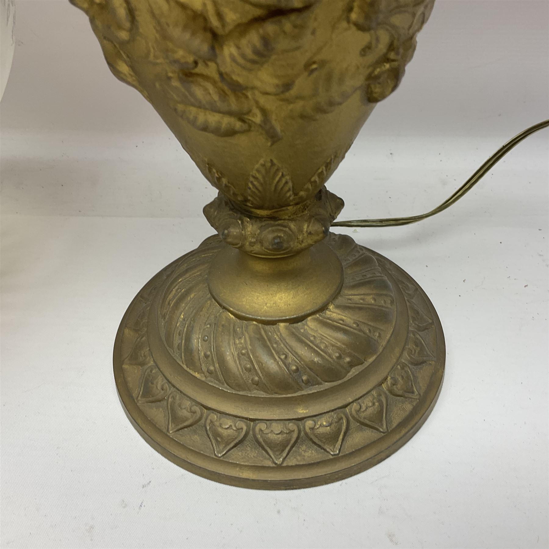 Gilt metal table lamp, heavily embossed with flowers and butterflies, with fluted frosted glass shade, H56cm