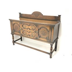 Early 20th century oak sideboard, raised shaped back, two cupboards flanking two drawers, baluster supports joined by stretchers