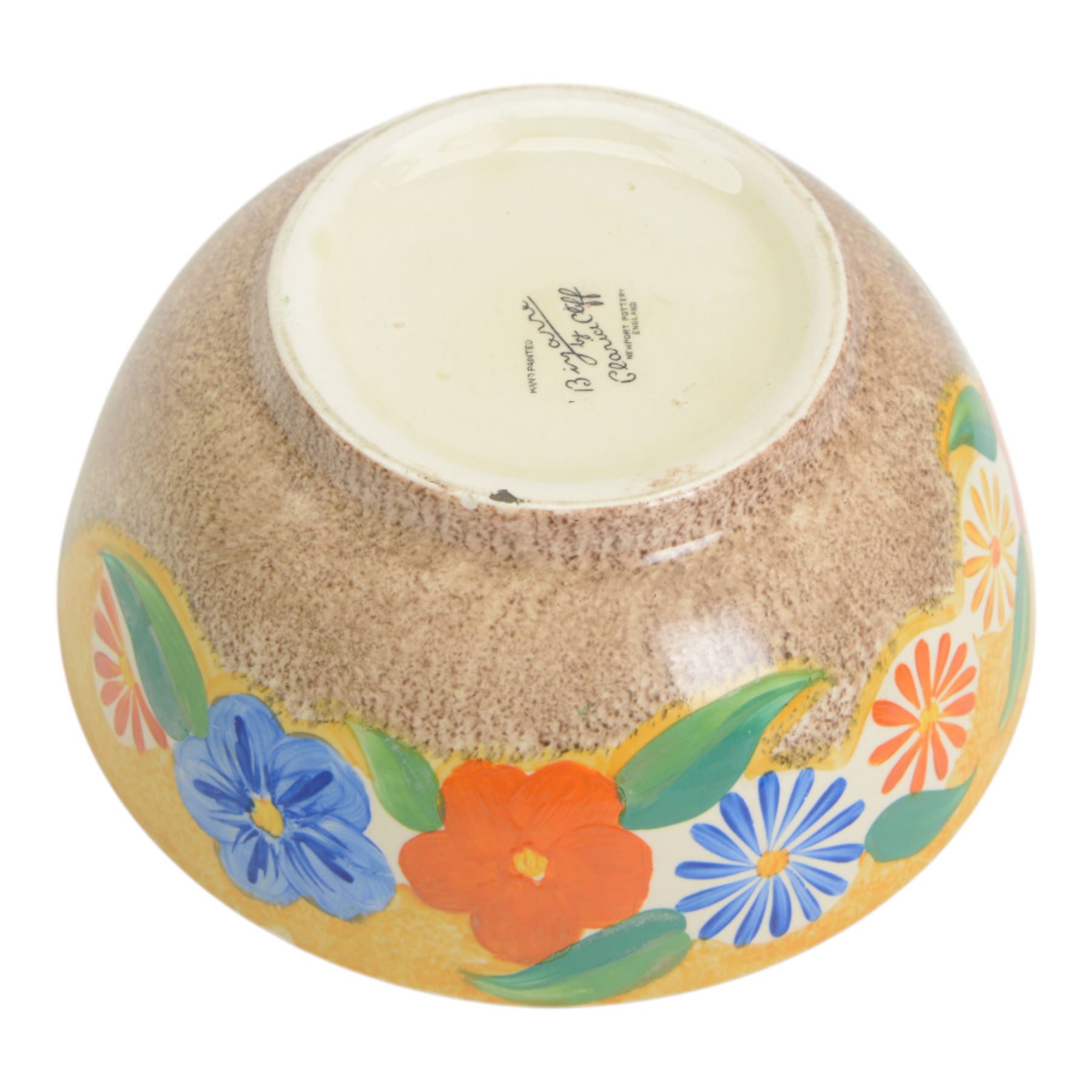 1930s Clarice Cliff Bizarre for Newport Pottery bowl, decorated in the Canterbury Bells pattern, the exterior painted with stylised flowers in blue, yellow and orange amongst foliage upon a brown and yellow Cafe au Lait stippled ground, with black printed mark beneath, D18cm