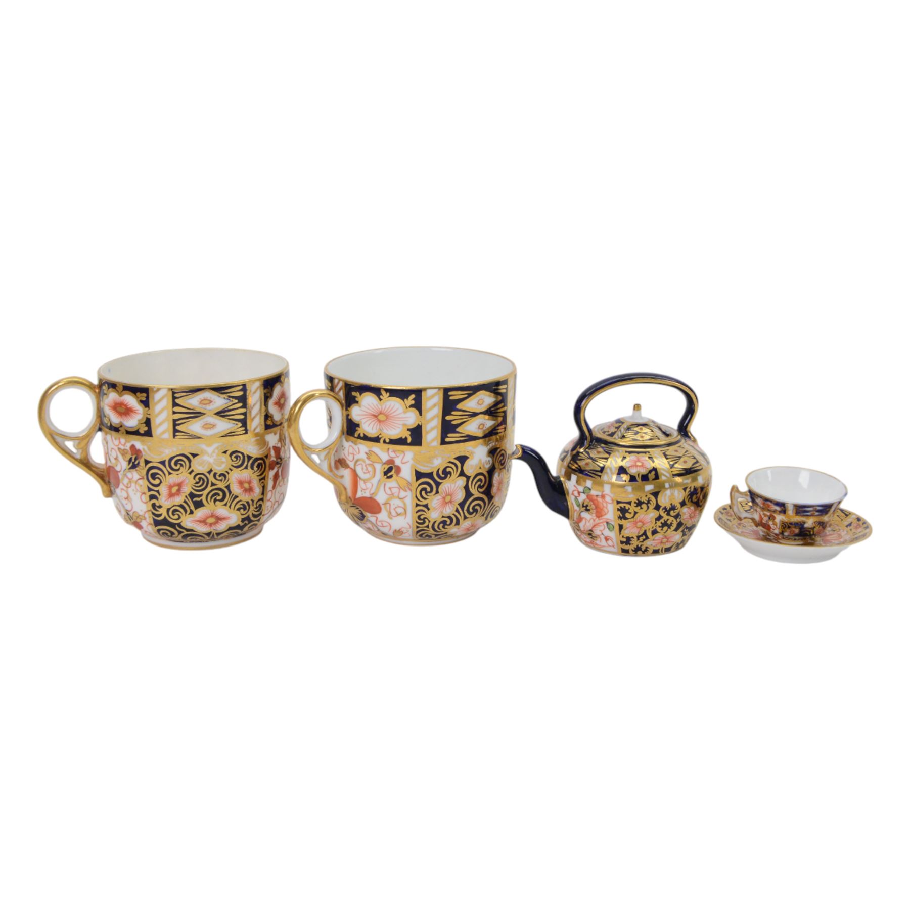Royal Crown Derby imari pattern, miniature teapot and teacup, together with two cups and saucers and three plates