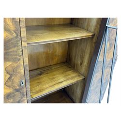 Art Deco burr walnut drinks cabinet, geometric central glazed astragal door enclosing two fixed shelves, flanked by symmetrical bookmatched veneered cupboards with drawers above 