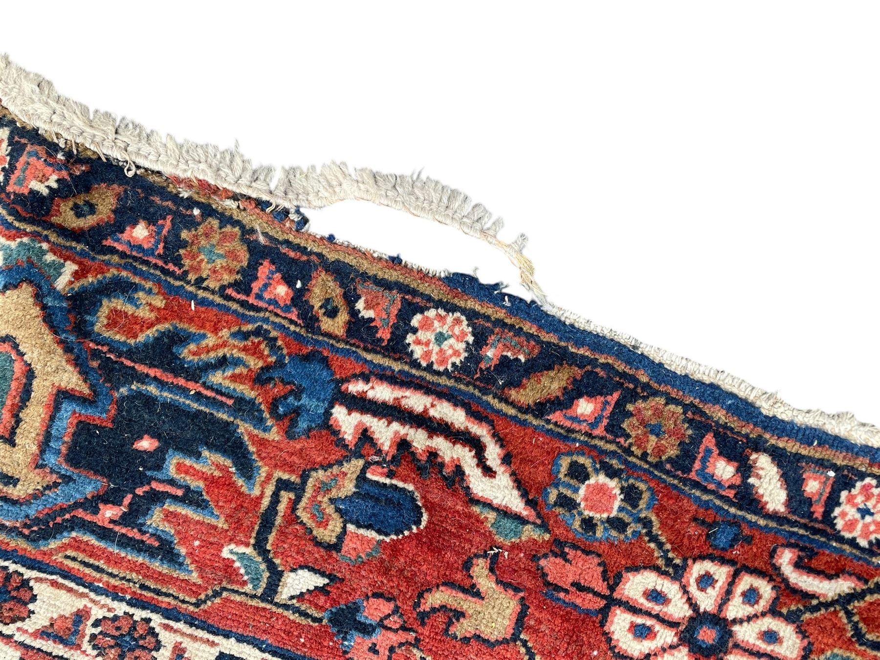 Persian blue ground carpet, the field divided up into panels by trailing bands with flower heads, each panel decorated with palmettes and stylised plant motifs, the border decorated with further palmettes, within floral pattern guard stripes 