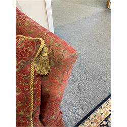 Large Knole design hardwood-framed three-seat drop-arm sofa, upholstered in crimson fabric decorated with trailing acanthus leaves and shields, together with scatter cushions 