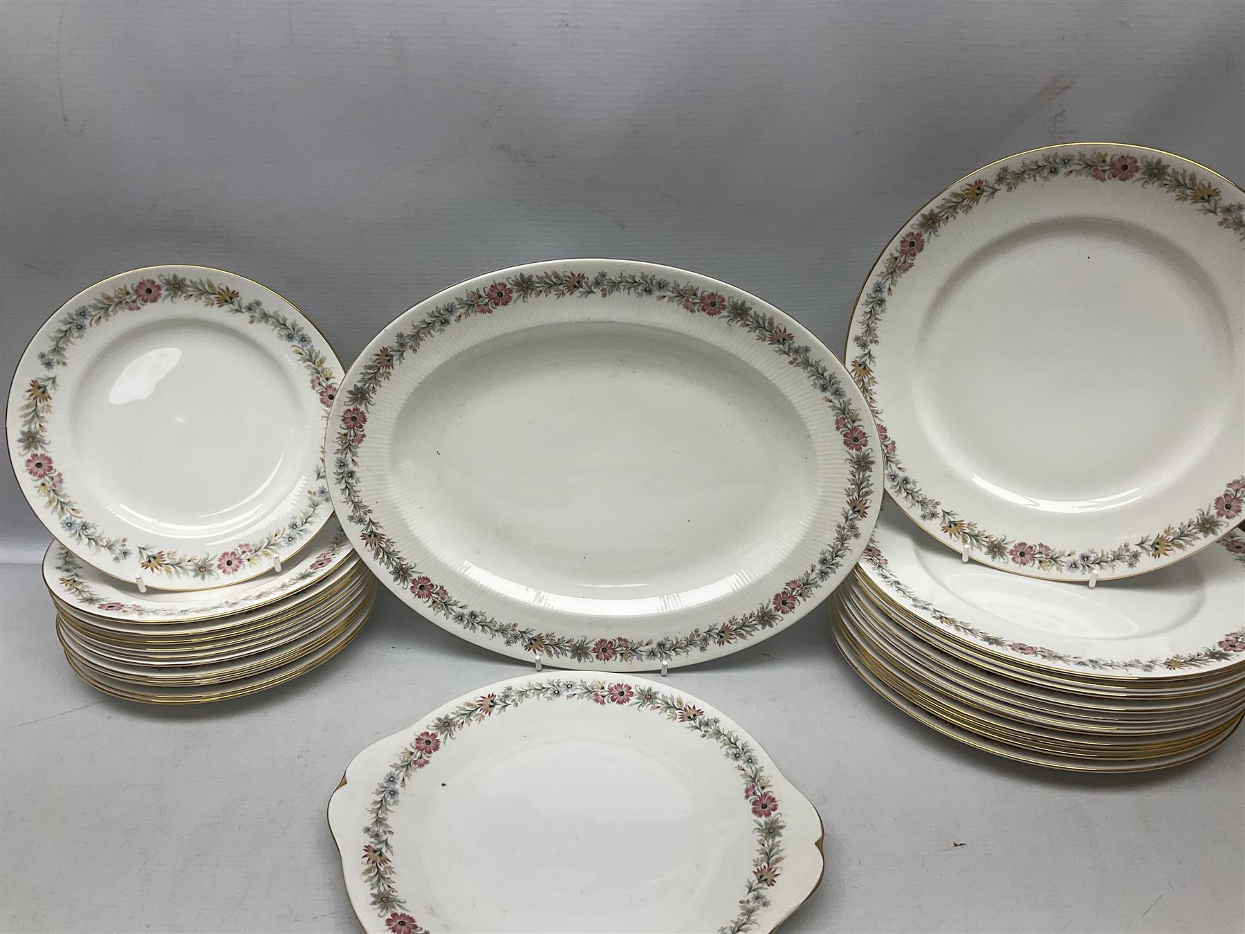 Royal Albert Paragon tea and dinner service for twelve decorated in the Belinda pattern, comprising fourteen saucers, twelve teacups, thirteen side plates, teapot, sauce boat and stand, salt and pepper shakers, two jugs, sucrier, twelve dinner plates, twelve smaller plates, two lidded tureens, twelve bowls, twelve smaller bowls, cake plate, oval plate and oval dish (100)