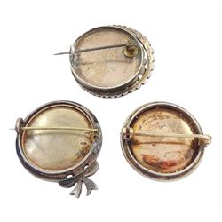 Three 19th century silver portrait brooches, each set with miniatures of women in 18th century dress on ivory, two with seed pearl surrounds and the other within a foliate paste set surround. This lot has been registered for sale under Section 10 of the APHA Ivory Act