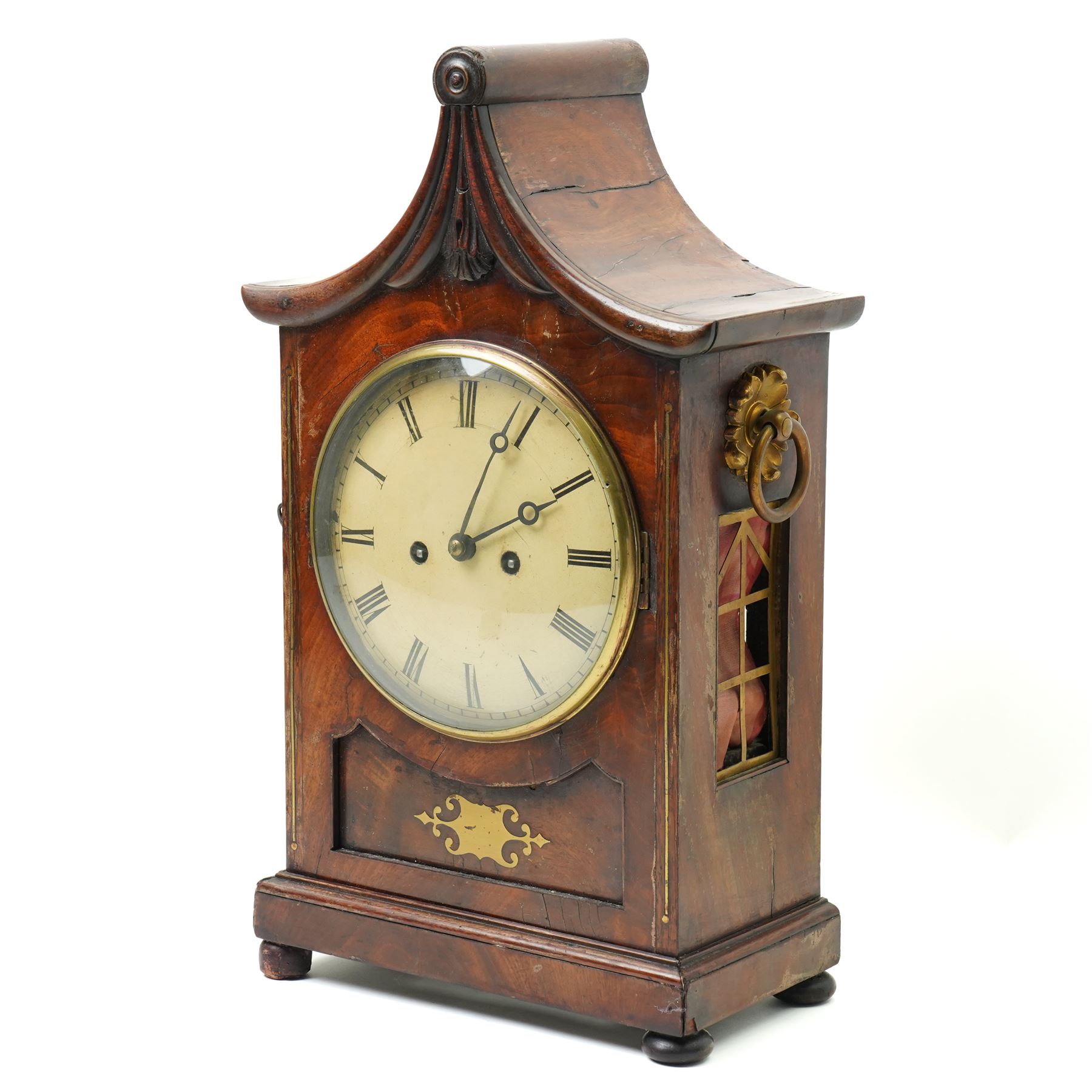 William IV mahogany and brass mounted bracket clock, the rectangular case with swept pagoda top with acanthus carved and rosette applied decoration, the sides with circular pierced brass fabric covered apertures and brass carrying handles, dial with 8 inch painted Roman chapters with pierced steel hands, the brass four pillar twin wire fusee 8-day movement with anchor escapement striking on a bell, lacking pendulum 