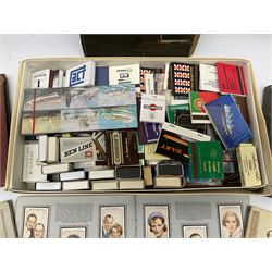 Collection of match boxes and cigarette cards in albums, mostly Wills, to include Radio Celebrities, various topographic examples, locomotives, coats of arms, flowers, etc., 