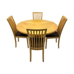 Skovby - 'SM32' late 20th century beech circular extending dining table circular segmented top turning to activate a patented spring loaded triple leaf extension stored within the cylindrical column base (Extended diameter 146cm); and set of four chairs (Width 47cm, Depth 56cm, Height 95cm, Seat height 47cm)