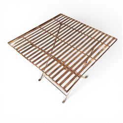 Pair of French 1920's wrought metal folding bistro café tables, the strapwork top over a folding X-frame base, in rustic white painted finish