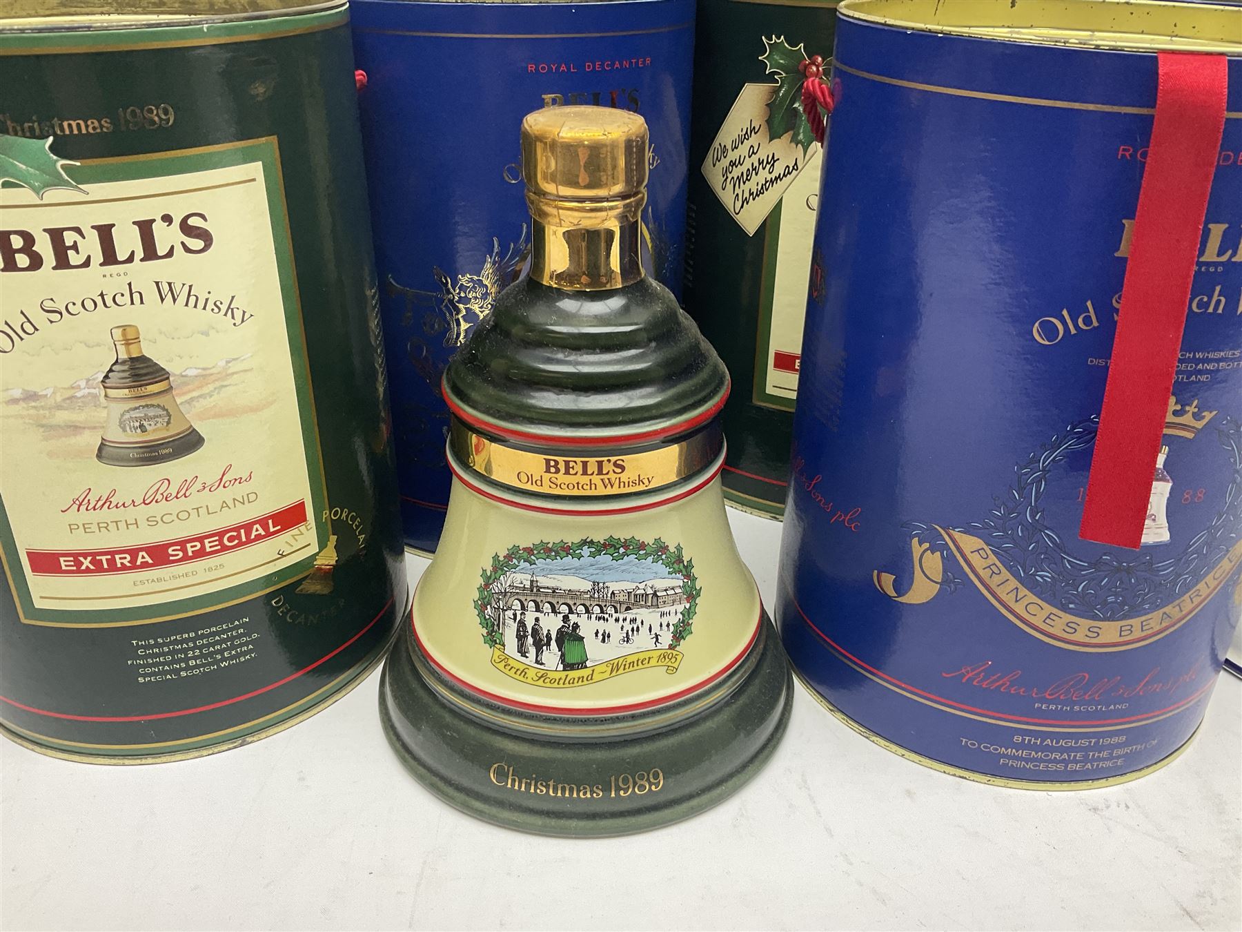 Bells, Scotch whisky, in seven Wade ceramic decanters, including Christmas 1988, 1989, 1990, 1991 etc