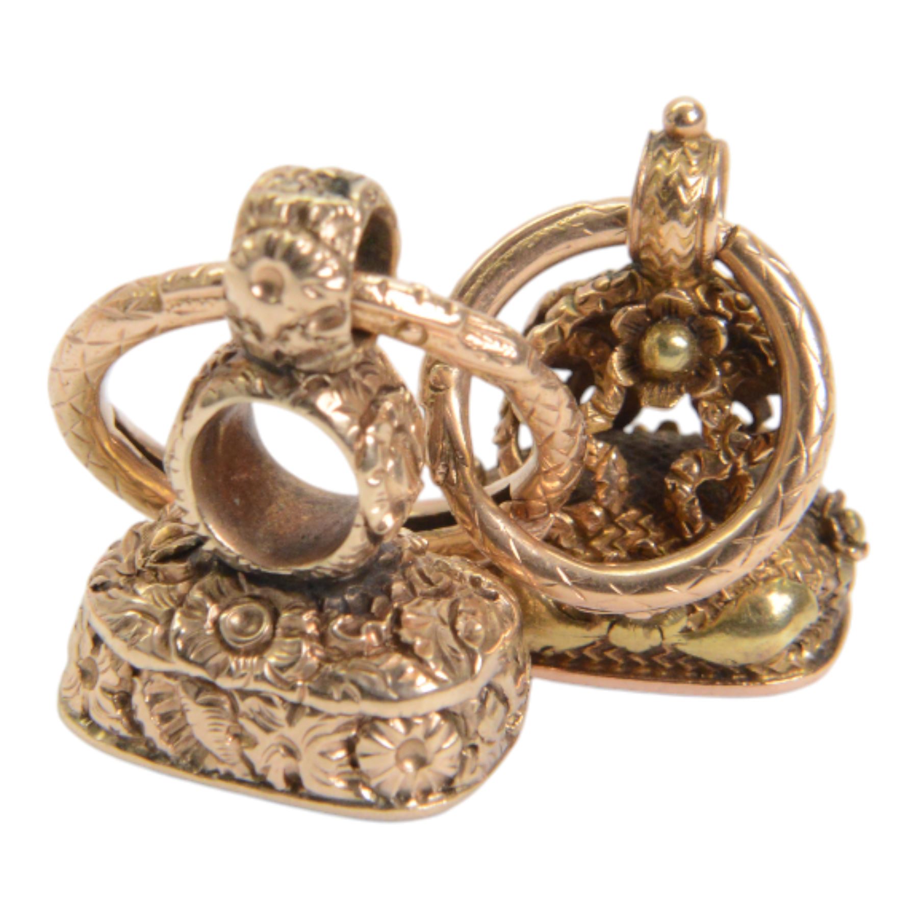 Two late 18th/early 19th century gold fob seals, the first 12ct example with amethyst matrix engraved with the letter D, the second 18ct example with bloodstone matrix, each within a foliate mount united by two 14ct ouroboros snake split rings, each seal approximately H2.5cm

Provenance: By family descent from the Chichesters of Arlington Court, Devon; from the collection of Andrew Chichester Everitt.