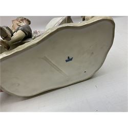 Lladro figure, Poetry of Love, modelled as a boy seated reading from a book next to a girl on garden bench with a dog at her feet, sculpted by Regino Torrijos, with original box, no 5442, year issued 1987, year retired 1998, H22cm