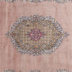 South East Persian Kirman hand-knotted rug, pale blush field with central scalloped medallion within an elaborate scalloped cartouche, spandrels filled with fine scrolling vine-work, palmettes and floral sprays, enclosed by wide and narrow borders in soft tones of blush pink, ivory, powder blue, sage green and pale gold, with cotton fringe ends 