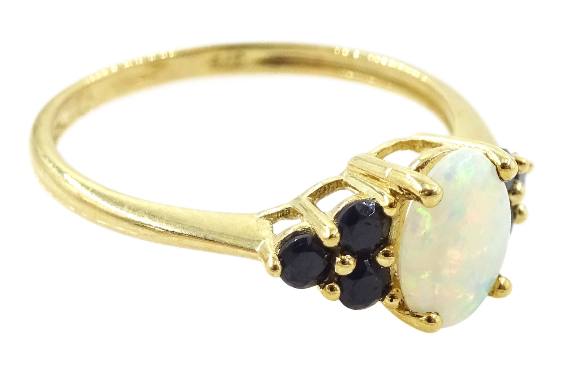 9ct gold opal and sapphire ring, single oval cut opal, with three sapphires set either side, hallmarked
