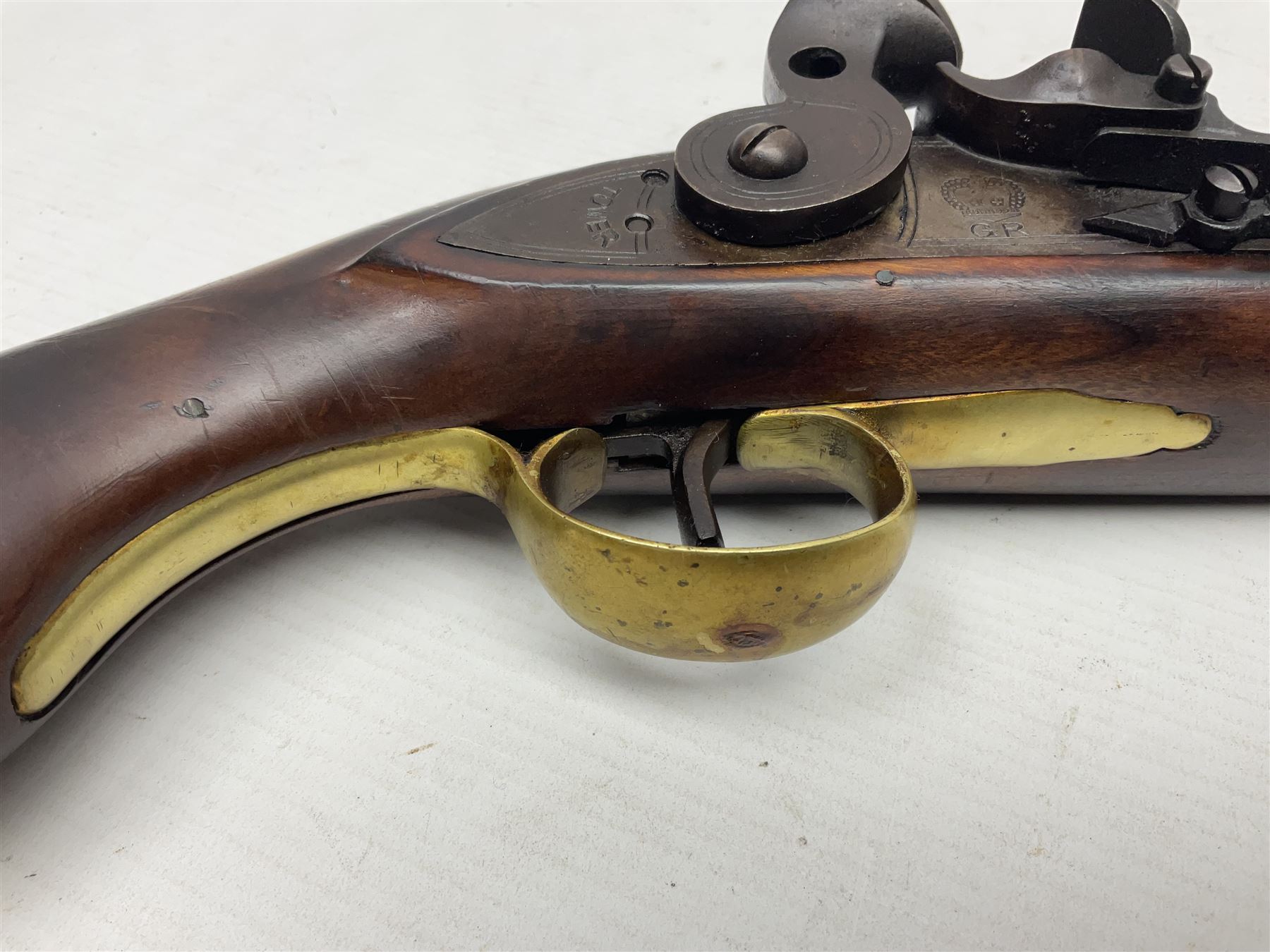 Modern non-firing reproduction Tower flintlock pistol marked with crowned GR and Tower to the lock, brass skull crusher butt and fittings L40cm overall; another Indian/Moorish reproduction flintlock pistol with mother-of-pearl inlay; and a modern die-cast replica Colt style revolver (3)
