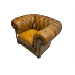 Chesterfield armchair, upholstered in buttoned tan leather with studded detail, on turned feet