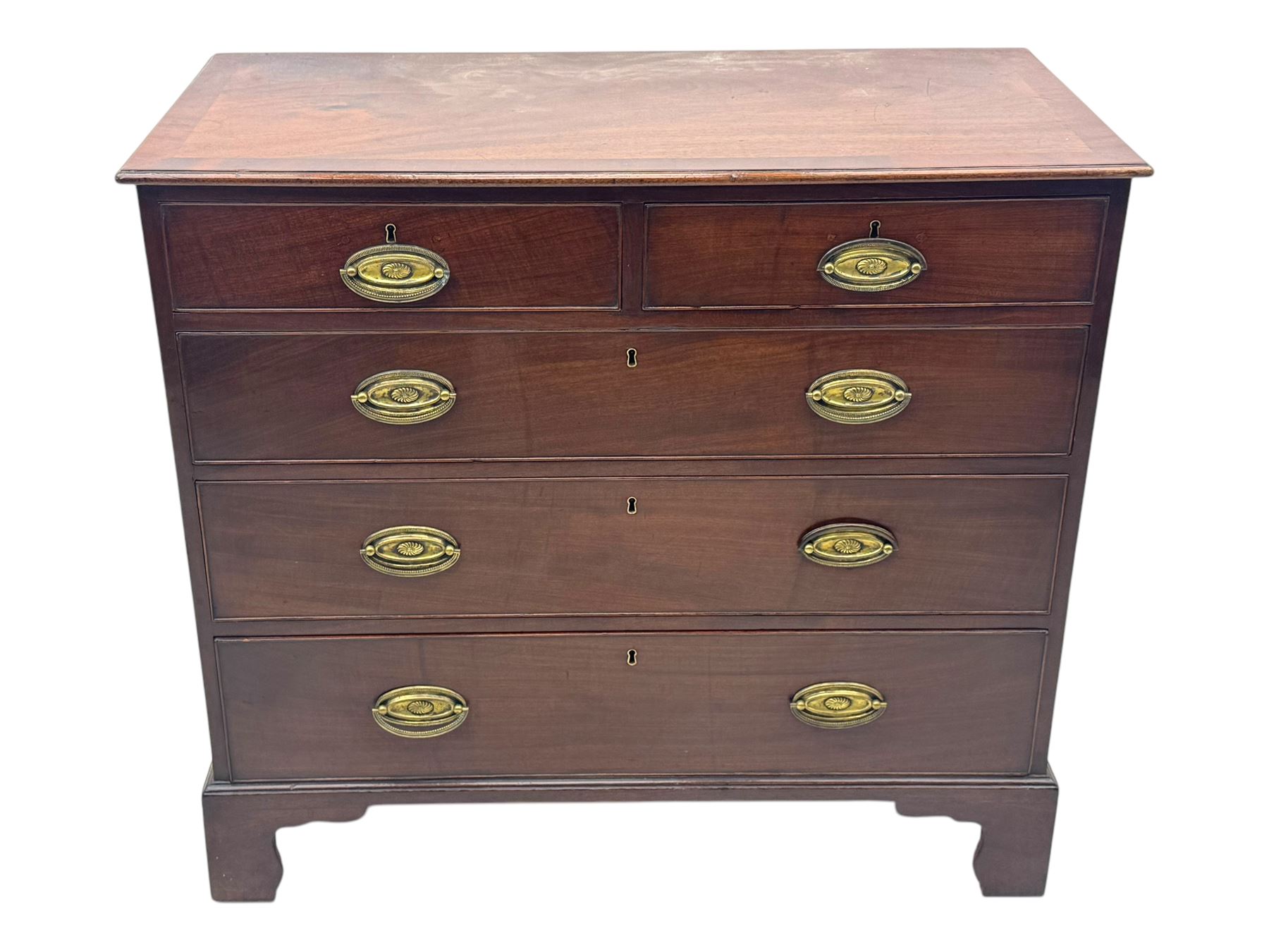 George III mahogany chest, rectangular top with moulded edge over two short and three long graduated cockbeaded drawers, each fitted with brass oval handles, on bracket feet