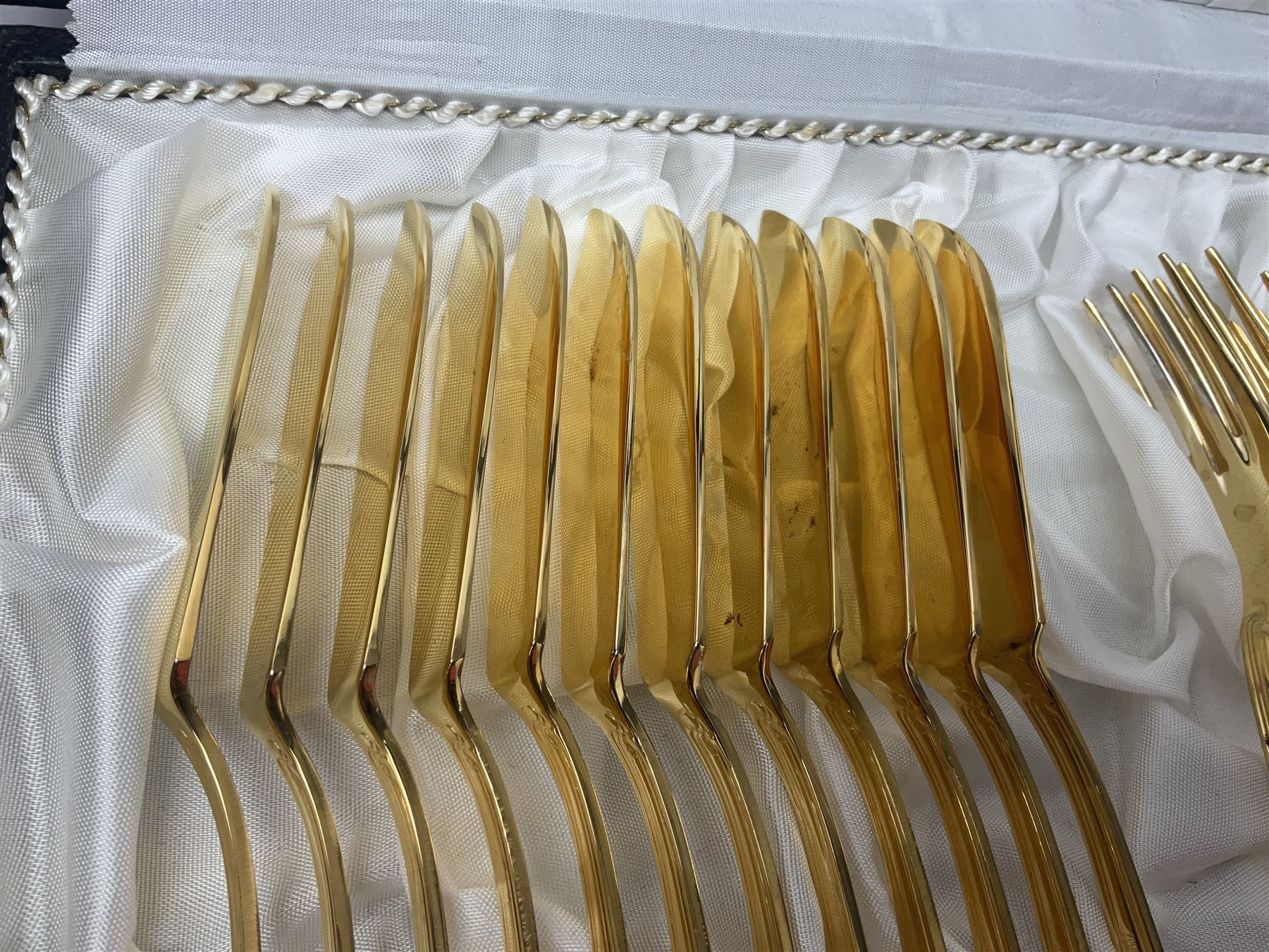 Bestecke Solingen canteen of gold plated cutlery for twelve place settings, including ladle, cake slice and serving spoons, contained within a briefcase, together with a matching set twelve of Bestecke Solingen gold plated fish knives and forks, in fitted case 