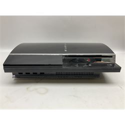 Sony PlayStation 3 60GB console with one PS3 controller, two PS2 controllers, BD remote control, PSP handheld gaming console with case, GAMEware PSP essentials pack, and a selection of PS2, PS3 and PSP games in original cases with instruction booklets 