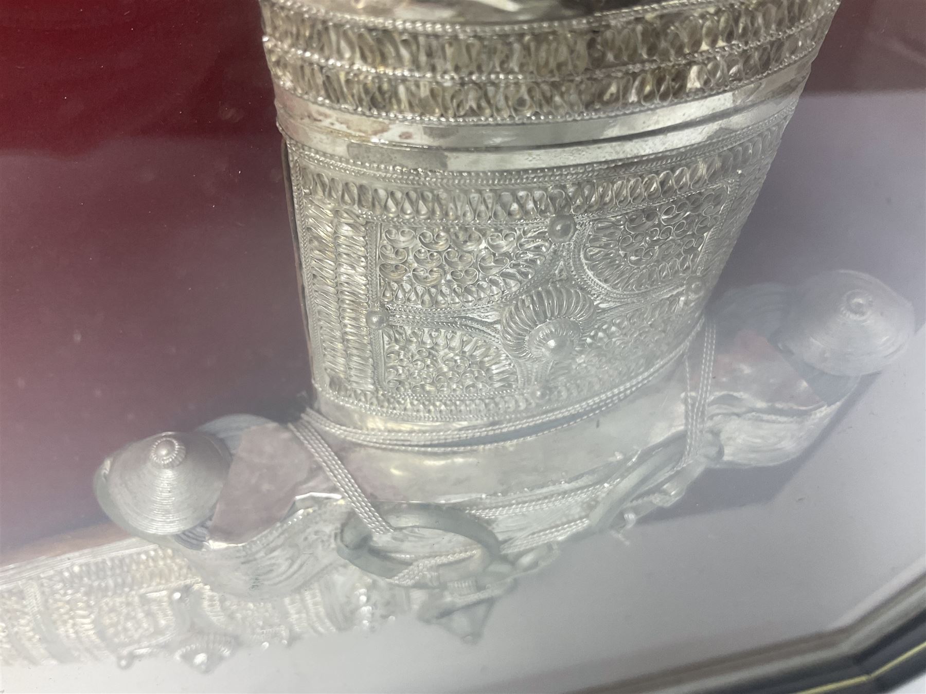 20th century silver Khanjar dagger from Oman, heavily decorated with filigree throughout, dome shaped pommel and waisted grip, the sheath with fastening rings, with miniature curved dagger accessory, housed in red lined glazed box frame, L38cm