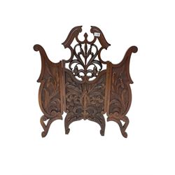 Late 19th century carved mahogany fire screen, broken swan neck pediment with carved and pierced foliate and flower design, raised on scrolled supports