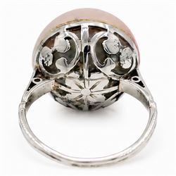 Early 20th century 18ct white gold pink mabe pearl ring, with pierced design floral and scroll gallery