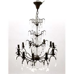 Contemporary bronze finish twelve branch chandelier, decorated with glass droplets 