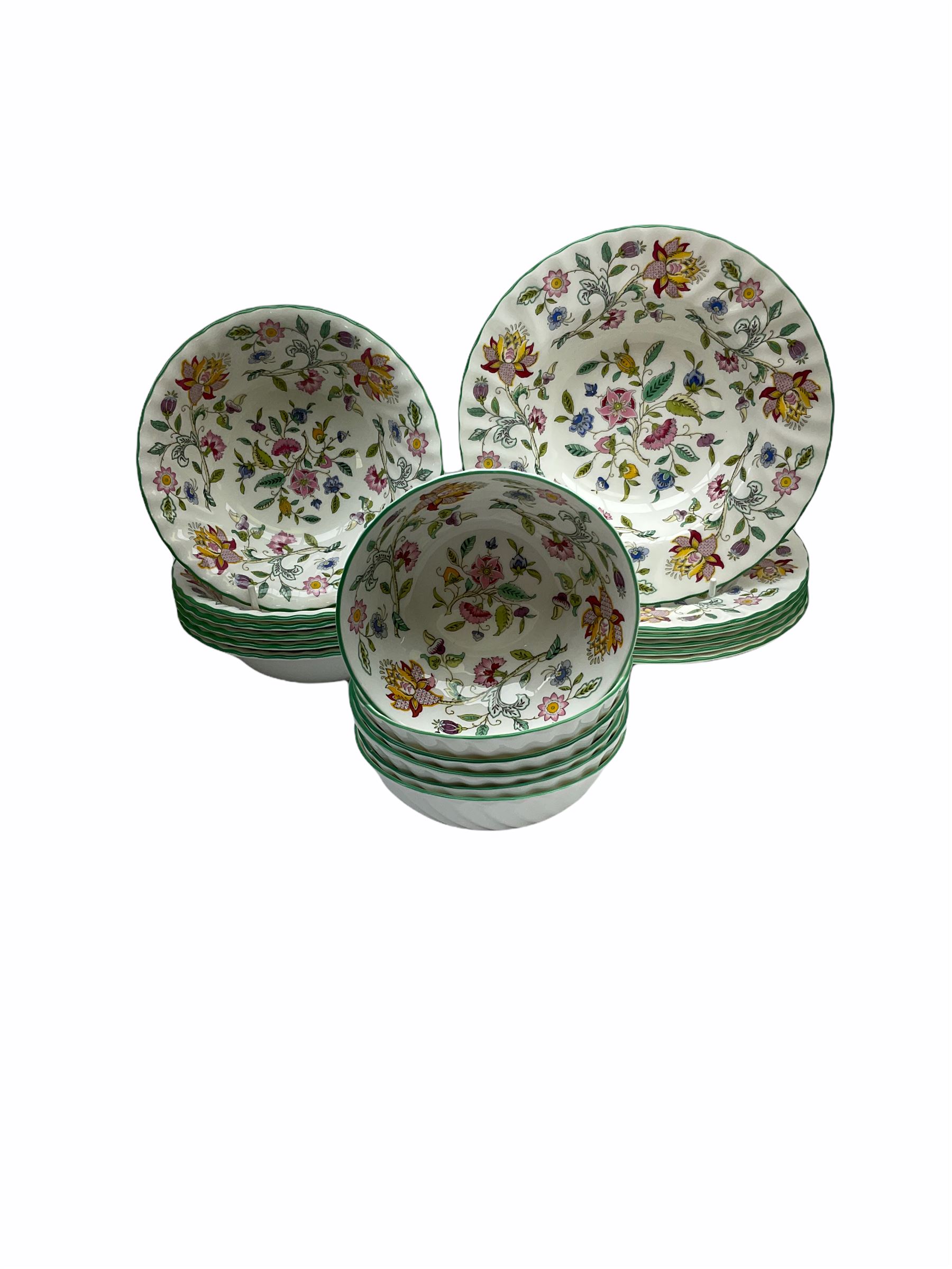 Minton Haddon Hall pattern tea and dinner wares, including basket dish, two covered tureens, six dinner plates, eight dessert plates, twelve tea plates, six soup bowls, six cereal bowls, teapot, coffee pot, milk jug, covered sucrier twelve tea cups and saucers, six mugs, footed bon bon dish, pair of candlestick holders, cake knife and slice etc (81)