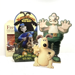  Wallace & Gromit - large shop promotional three dimensional  cardboard cut-out advertising the launch of the DVD 'The Curse of the Were-Rabbit' H152cm another large shop folding cardboard cut-out for displaying merchandise depicting The Wrong Trousers H146cm: smaller cut-out depicting seated Gromit H93cm and Waterstones Christmas 2004 in-store cardboard promotional stand  
