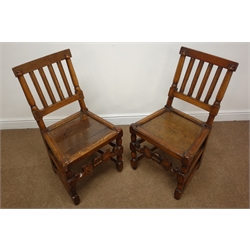Pair of country made late 17th/18th century oak chairs, moulded slat backs and solid seats on turned supports with carved front and plain side stretchers, H87cm