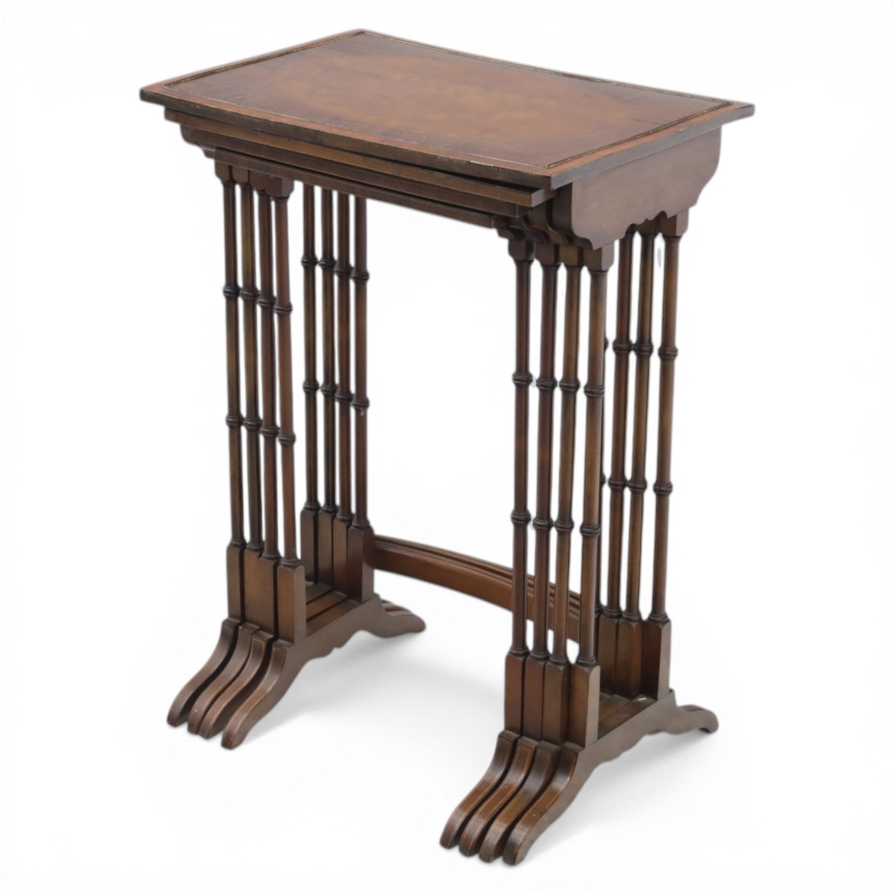 20th century mahogany quartetto nest of tables, the rectangular tops with oval inlay, upon turned knopped supports, united by a curved stretcher, raised upon outswept feet