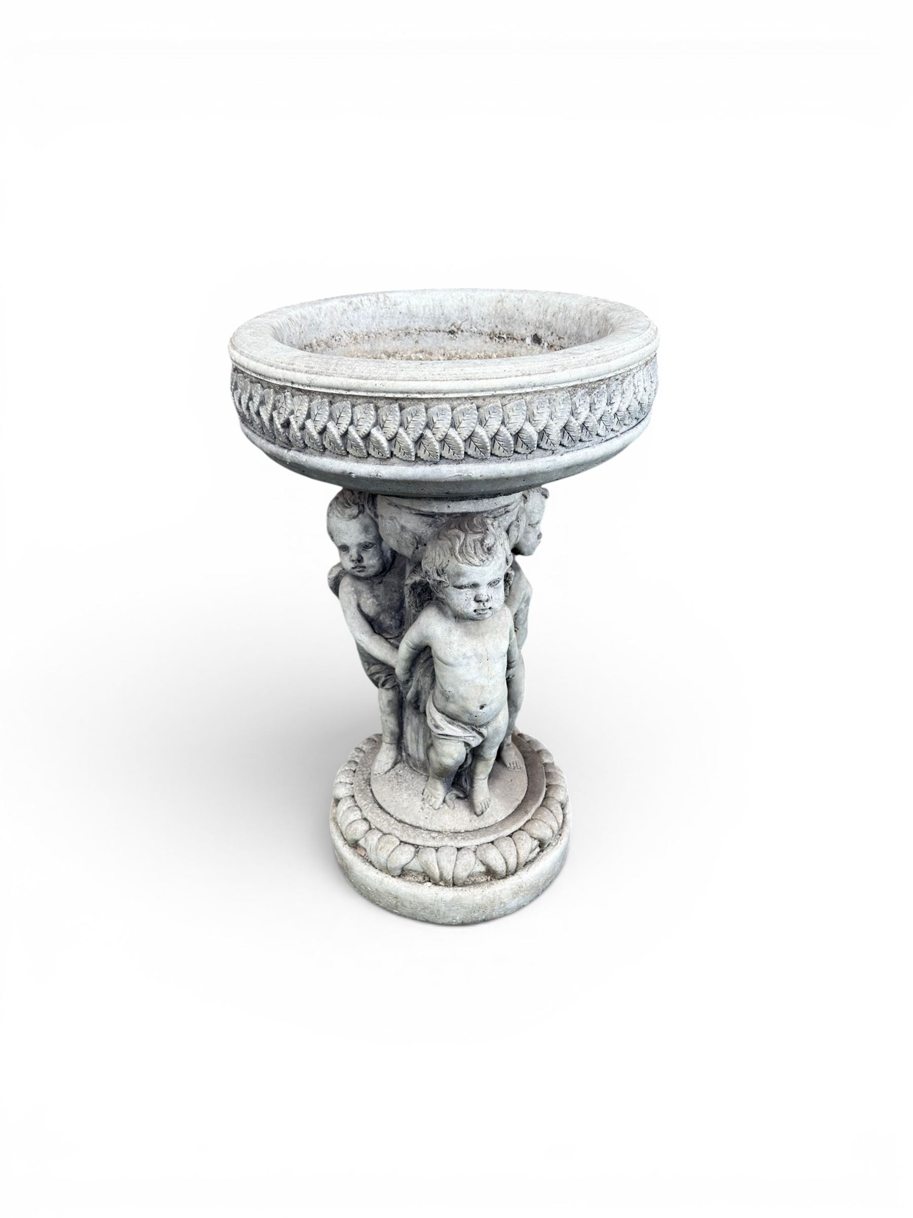 Cast stone cherub bird bath, circular removable top raised on three cherubs with ornate detailing