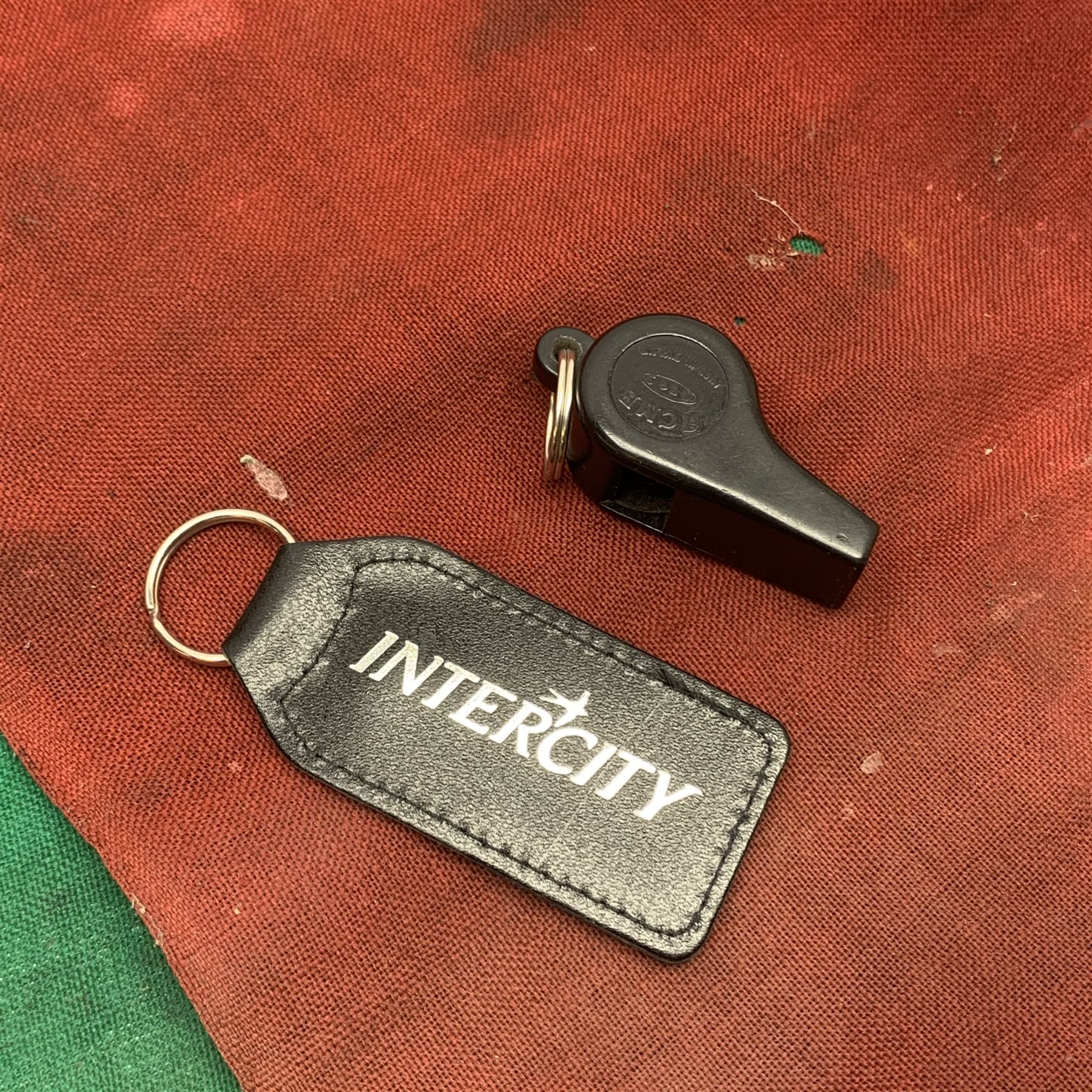  British Rail 'Pilotman' armband, British Rail Guard's red and green flags and Acme whistle, BR 1988 presentation camera and 1996 paperweight and Intercity keyring  