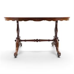 Victorian mahogany breakfast table, oval moulded top over a shaped frieze, on twin pierced lyre-form end supports with moulded scroll feet, united by a turned stretcher, on castors