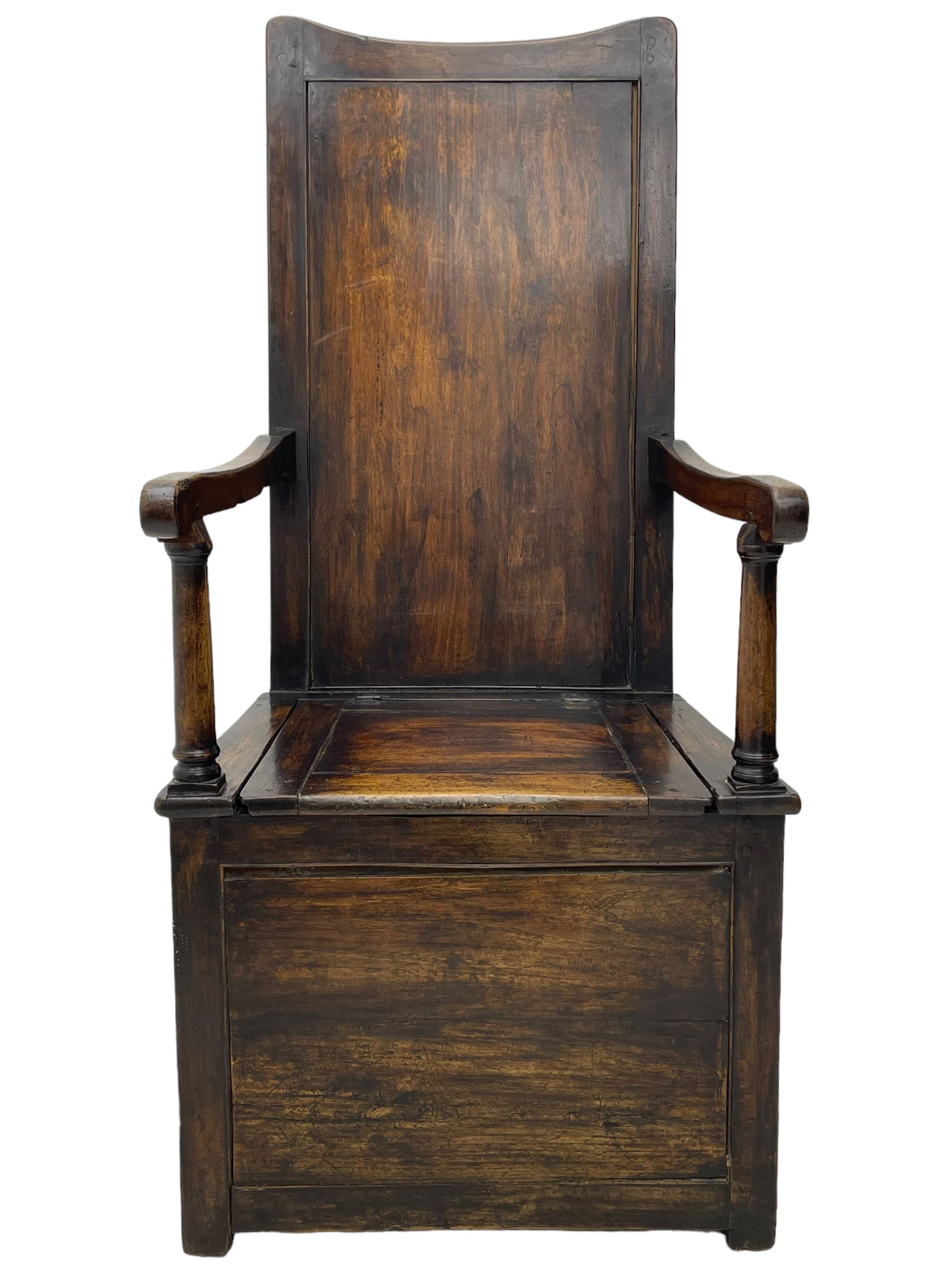 18th century elm box-seat lambing chair, dished cresting rail over panelled back, panelled hinged lid flanked by two turned arm supports