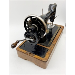 A vintage mid 20th Century cased Singer manual sewing machine, within faux crocodile carry case.